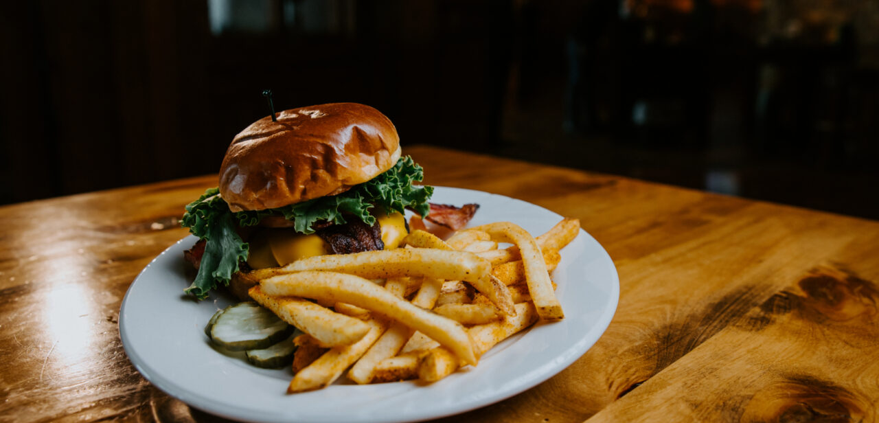 Close up of delicious looking cheeseburger with fries