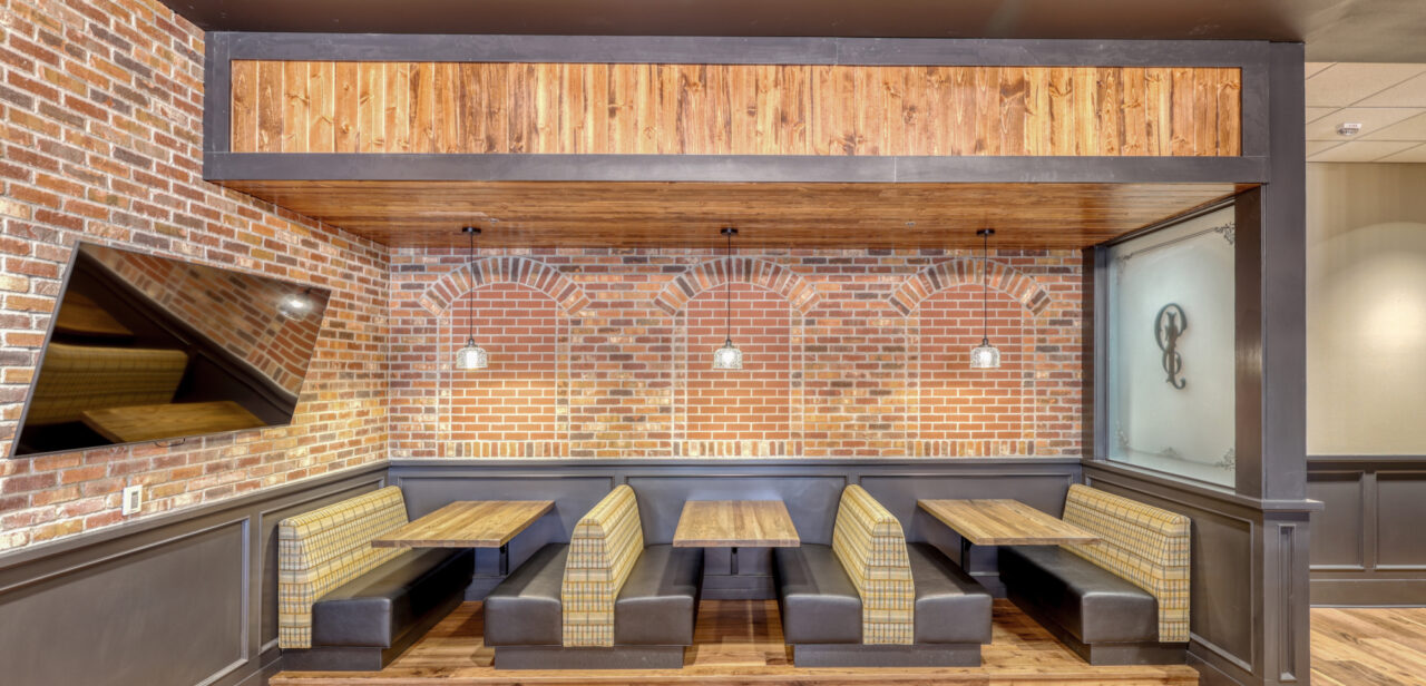 An image that showcases the booth seating and a TV at Preacher Smiths Taproom & Commons.