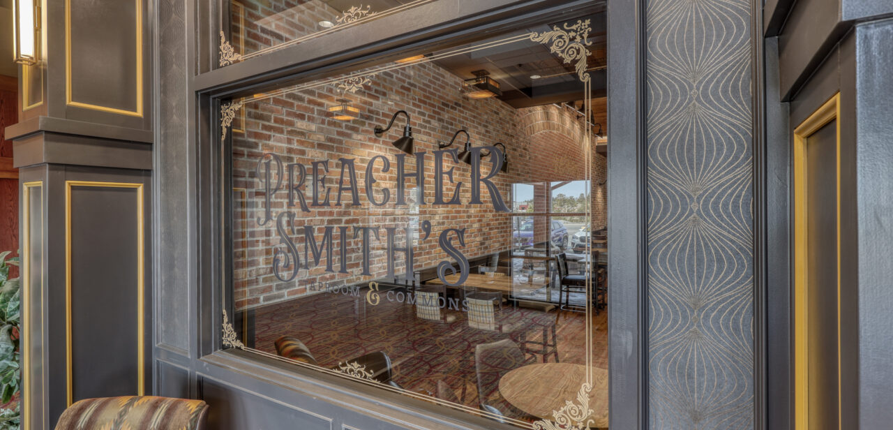 An Image of the front entrance window at Preacher Smith's Taproom & Commons